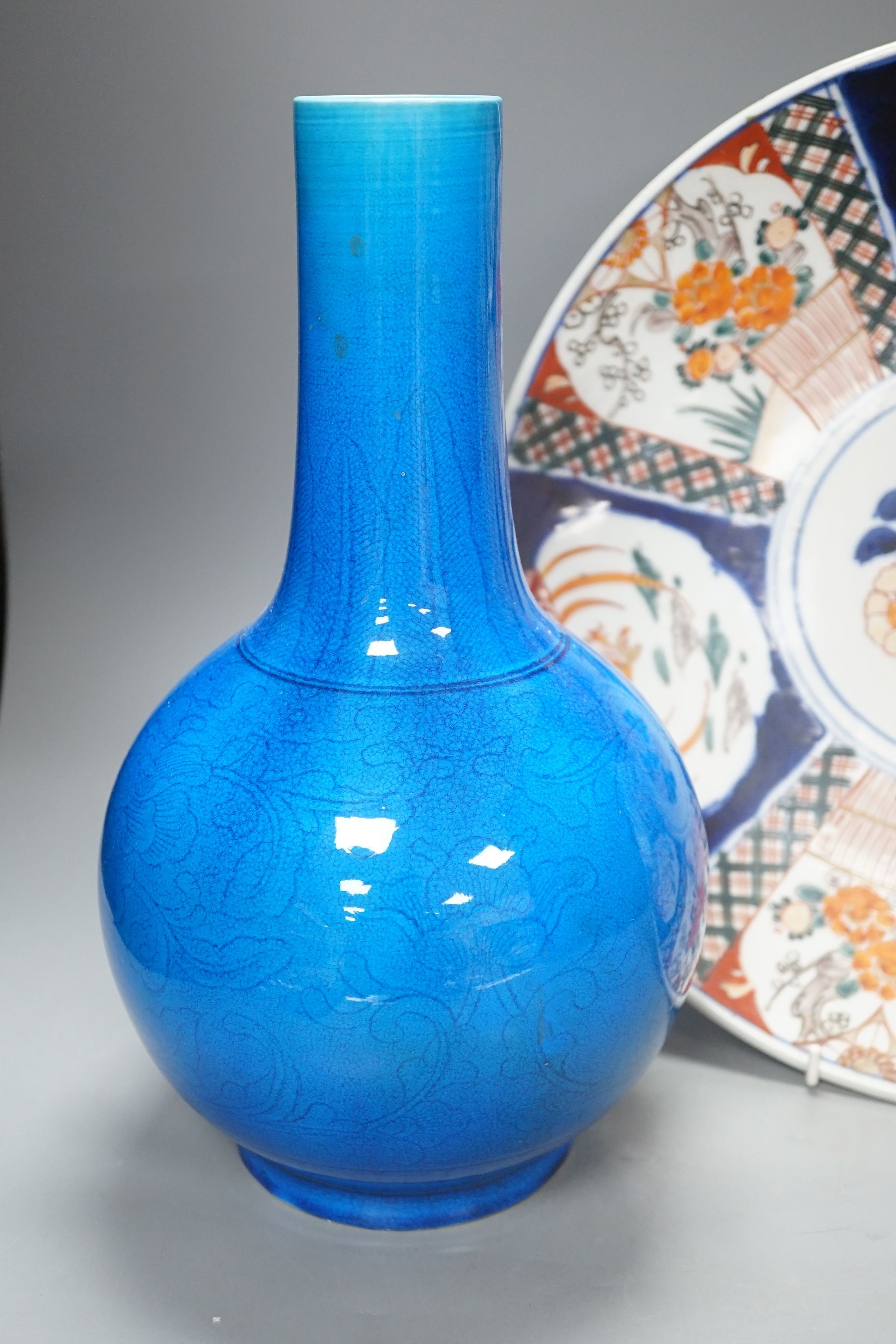 A large Japanese turquoise glazed bottle vase and an Imari dish, dish 37 cms diameter.